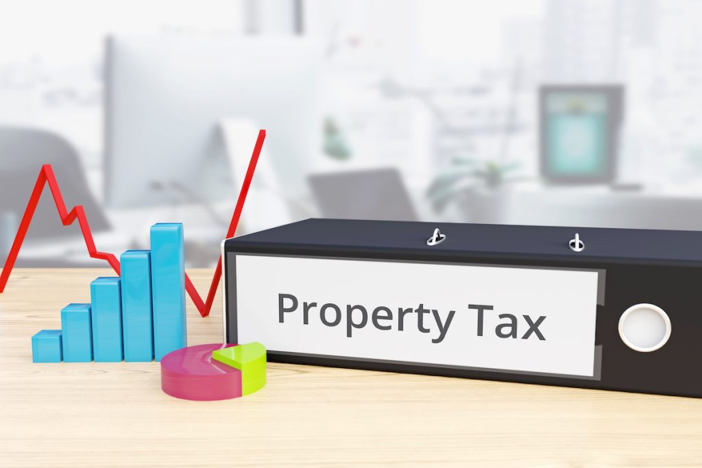 Property Tax – Finance/Economy. Folder on desk with label beside diagrams. Business/statistics. 3d rendering